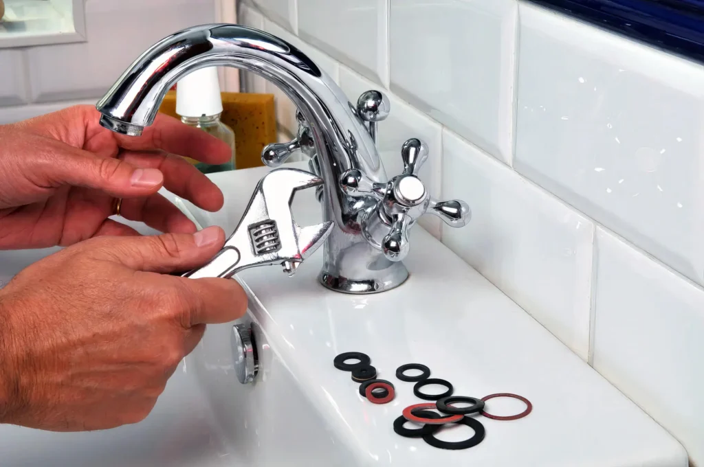 Plumber performing maintenance on a bathroom faucet in Temecula