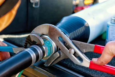 Technician tightening an industrial pipe connection in Temecula