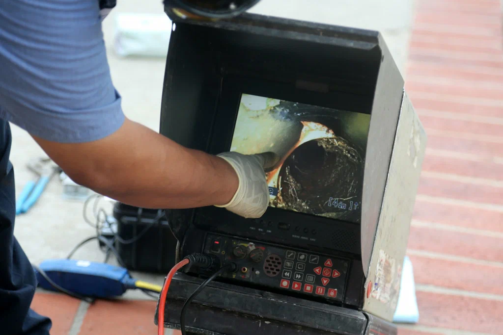 Technician viewing a drain inspection camera in Temecula