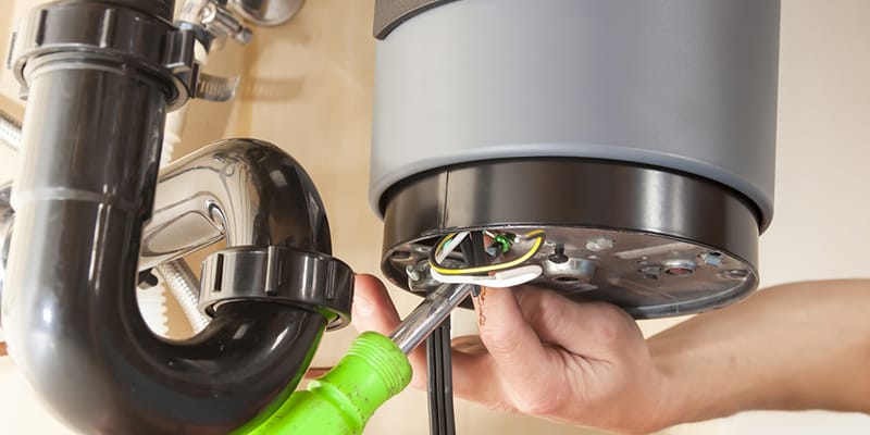 Technician repairing the heating element of a water heater in Temecula