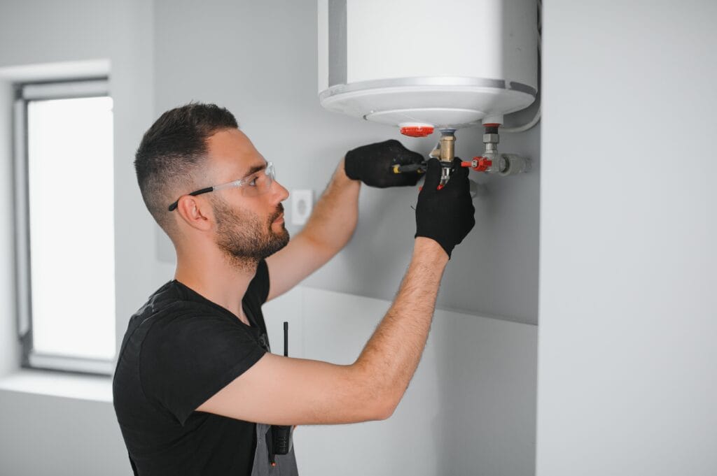Technician performing water heater maintenance in Temecula