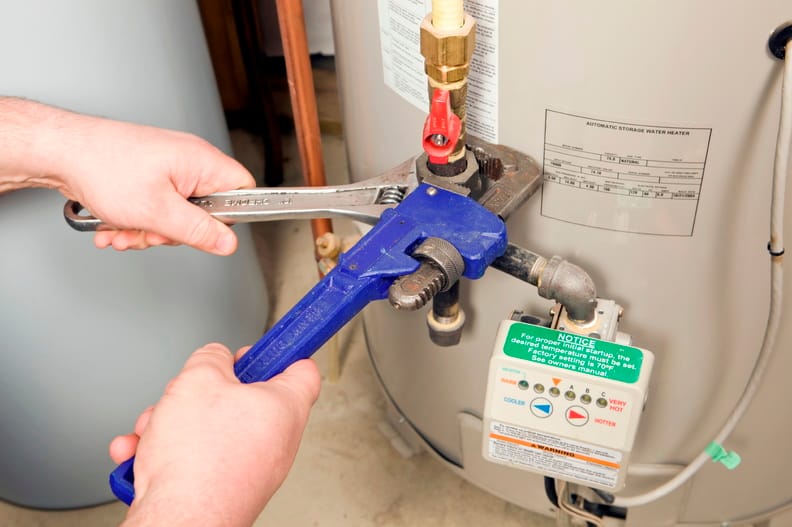 Plumber repairing a water heater valve in Temecula